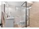 Modern bathroom featuring a glass enclosed shower, sleek vanity, and neutral color palette at 1568 S Dudley Ct, Lakewood, CO 80232