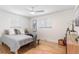 Bright bedroom with hardwood floors, two windows, and guitar decor at 1568 S Dudley Ct, Lakewood, CO 80232