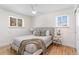 Cozy bedroom with two windows, hardwood floors, a ceiling fan, and a comfortable queen bed at 1568 S Dudley Ct, Lakewood, CO 80232