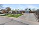 Lovely home with a spacious driveway leading to a detached garage and a well-manicured front yard at 1568 S Dudley Ct, Lakewood, CO 80232