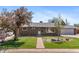 Charming brick home with well-maintained lawn, mature trees, and a walkway leading to the front door at 1568 S Dudley Ct, Lakewood, CO 80232
