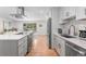 Modern kitchen with an open floor plan, stainless steel appliances, and white cabinets at 1568 S Dudley Ct, Lakewood, CO 80232