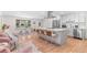 Modern open kitchen with stainless steel appliances, white cabinetry, and a large center island with bar seating at 1568 S Dudley Ct, Lakewood, CO 80232