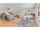 Open-concept living space with kitchen island, dining area, and a cozy seating area, great for entertaining at 1568 S Dudley Ct, Lakewood, CO 80232