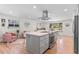 Spacious open-concept area with a modern kitchen island, living and dining space with lots of sunlight at 1568 S Dudley Ct, Lakewood, CO 80232