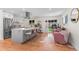 Bright open-concept kitchen and living space with a large island, modern appliances, and access to the backyard at 1568 S Dudley Ct, Lakewood, CO 80232