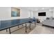 Spacious basement features a ping pong table and a cozy seating area, perfect for entertainment at 16308 E Wyoming Dr, Aurora, CO 80017