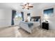 Relaxing primary bedroom with light wood floors, ceiling fan, and a large window, creating a calming space at 16308 E Wyoming Dr, Aurora, CO 80017