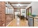Dining room area with exposed brick, hardwood floors and vintage detailing at 16308 E Wyoming Dr, Aurora, CO 80017