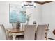 Traditional dining room with a wooden table set for six and decorative lighting at 16308 E Wyoming Dr, Aurora, CO 80017