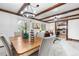 Bright dining room features exposed wood beams, decorative chandelier and open access to the kitchen and living room at 16308 E Wyoming Dr, Aurora, CO 80017