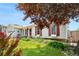 Well-maintained lawn and landscaping highlight this home with red shutters at 16308 E Wyoming Dr, Aurora, CO 80017