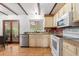Bright kitchen features hardwood floors and stainless steel appliances at 16308 E Wyoming Dr, Aurora, CO 80017