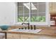 Kitchen sink and window with stylish bronze faucet and stone countertop at 16308 E Wyoming Dr, Aurora, CO 80017