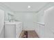 Functional laundry room equipped with modern washer, dryer, storage cabinets, and practical layout at 16308 E Wyoming Dr, Aurora, CO 80017
