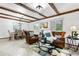 Inviting living room featuring exposed beams, warm lighting, and comfortable furniture at 16308 E Wyoming Dr, Aurora, CO 80017