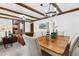 Open concept dining and living space with exposed beams and cozy seating at 16308 E Wyoming Dr, Aurora, CO 80017