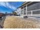 Backyard with a patio, adjacent sunroom, and a well-kept lawn, all under a sunny sky at 11796 Edenfeld St, Parker, CO 80134
