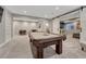 Recreational basement with a pool table and a cozy seating area for entertaining at 11796 Edenfeld St, Parker, CO 80134