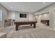 Spacious finished basement includes a pool table, seating, and game area at 11796 Edenfeld St, Parker, CO 80134