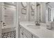Elegant bathroom featuring a modern vanity, stylish tile floor, and a tub with shower at 11796 Edenfeld St, Parker, CO 80134
