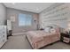 Inviting bedroom with a comfortable bed, whimsical music-themed wall art, and bright natural light at 11796 Edenfeld St, Parker, CO 80134