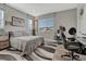 Modern bedroom features a bed, desk area, and lots of natural light at 11796 Edenfeld St, Parker, CO 80134