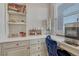 Desk area with white marble counters, white cabinets, and a built-in beverage center at 11796 Edenfeld St, Parker, CO 80134