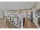 Spacious kitchen featuring an island with bar seating, stainless steel appliances, and ample cabinet space at 11796 Edenfeld St, Parker, CO 80134