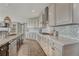Modern kitchen with granite countertops, stainless steel appliances, and tile backsplash at 11796 Edenfeld St, Parker, CO 80134