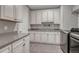 Functional laundry room with ample cabinet space, a sink, and modern washer/dryer units at 11796 Edenfeld St, Parker, CO 80134