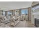Inviting living room with a fireplace, plush seating, and large windows offering scenic views, creating a warm atmosphere at 11796 Edenfeld St, Parker, CO 80134