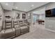 Home theater showcasing tiered seating, movie posters, and an adjacent billiards room at 11796 Edenfeld St, Parker, CO 80134