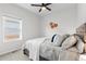 Bedroom with window, ceiling fan and wood-like headboard at 488 Vista Blvd, Lochbuie, CO 80603