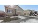 House exterior view with snow on the ground and a driveway at 488 Vista Blvd, Brighton, CO 80603