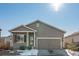 Gray siding ranch house with a two-car garage and snowy yard at 488 Vista Blvd, Brighton, CO 80603