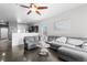 Spacious living room with L-shaped sectional sofa and hardwood floors at 488 Vista Blvd, Brighton, CO 80603