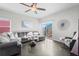Living area with grey sectional sofa and sliding glass door to backyard at 488 Vista Blvd, Brighton, CO 80603