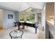Elegant music room with a grand piano and ample natural light at 2512 Premier Pl, Boulder, CO 80304