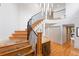 Elegant curved staircase with wrought iron railing at 2512 Premier Pl, Boulder, CO 80304