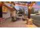 Cozy back patio with a pergola, outdoor seating, and ambient lighting at 9407 Dolton Way, Highlands Ranch, CO 80126