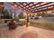 Relaxing back patio under a pergola, with cozy seating and lush backyard views at 9407 Dolton Way, Highlands Ranch, CO 80126