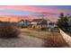 Large backyard with a patio, pergola, mature landscaping, and serene sunset views at 9407 Dolton Way, Highlands Ranch, CO 80126