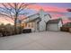 Backyard view featuring a well-lit patio with a hot tub and detached garage at 9407 Dolton Way, Highlands Ranch, CO 80126