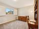 Bright bedroom with a window, wooden desk, and built-in shelving at 9407 Dolton Way, Highlands Ranch, CO 80126