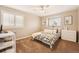 Bright bedroom with a patterned bedspread, shutters, and modern decor at 9407 Dolton Way, Highlands Ranch, CO 80126