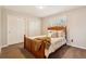 Bedroom features a wood-framed bed, double closets, and shuttered windows at 9407 Dolton Way, Highlands Ranch, CO 80126