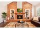 Living room showcasing brick fireplace, mantel, built-in shelves, and decor at 9407 Dolton Way, Highlands Ranch, CO 80126