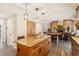 Kitchen island with granite countertops and stylish pendant lighting at 9407 Dolton Way, Highlands Ranch, CO 80126