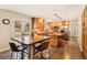 Well-lit kitchen features wood cabinets, stainless appliances, and island seating at 9407 Dolton Way, Highlands Ranch, CO 80126